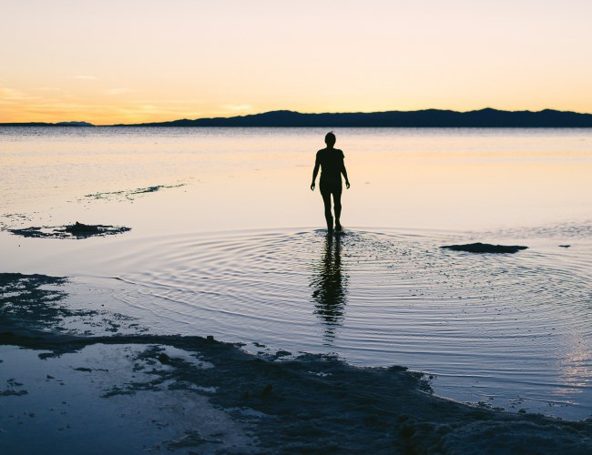 Person standing with ankles in the Great Salt Lake at golden hour. This Inland Sea is a rich source of minerals to help prevent trace mineral deficiency. Photo credit tory-morrison-661217-unsplash